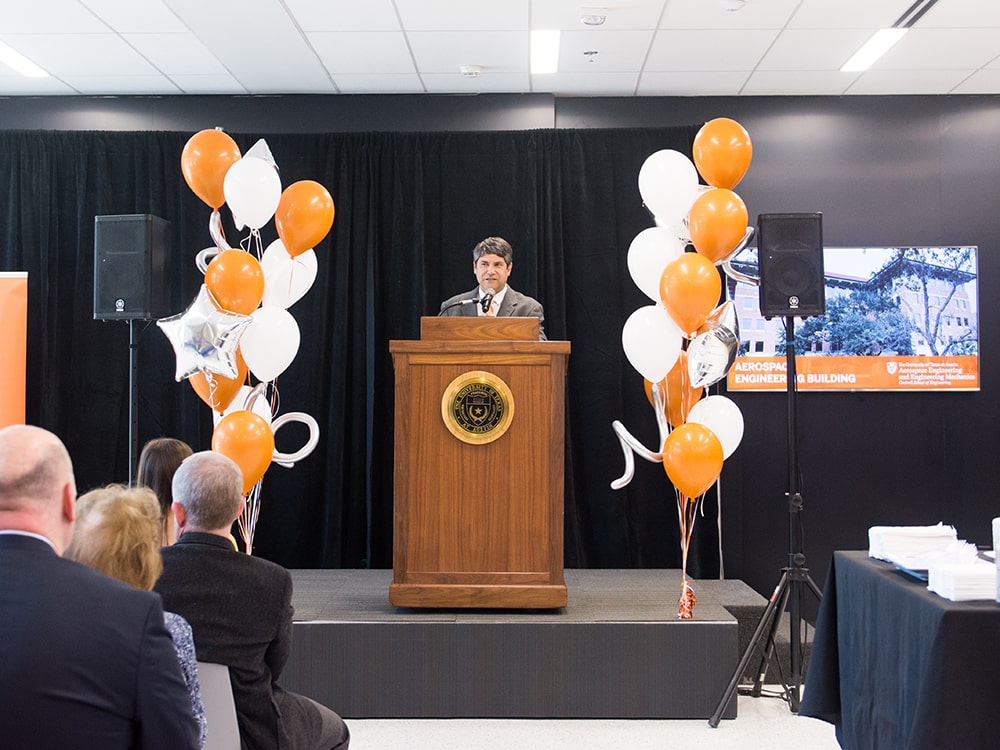 Noel Clemens giving speech at a podium for the Aerospace Engineering Building opening event