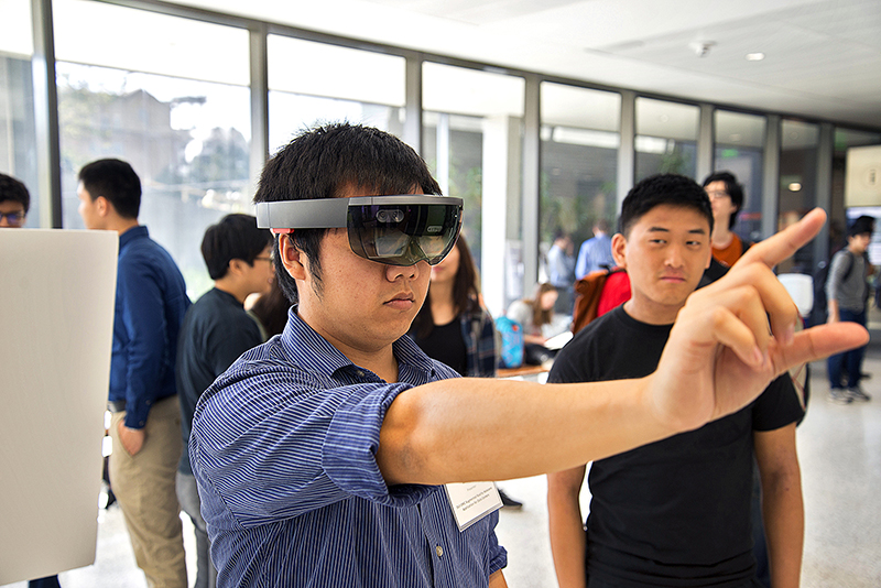 A student uses VR glasses during the Electrical and Computer Engineering Capstone Design Showcase.