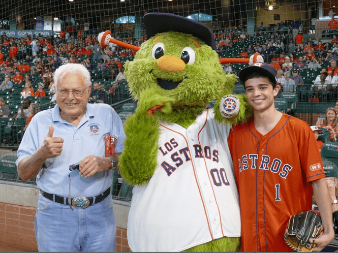 Lew Griffith smiling with Houston Astros mascot