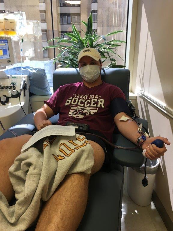Photo of COVID-19 survivor Connor Scott donating his blood plasma at a hospital.