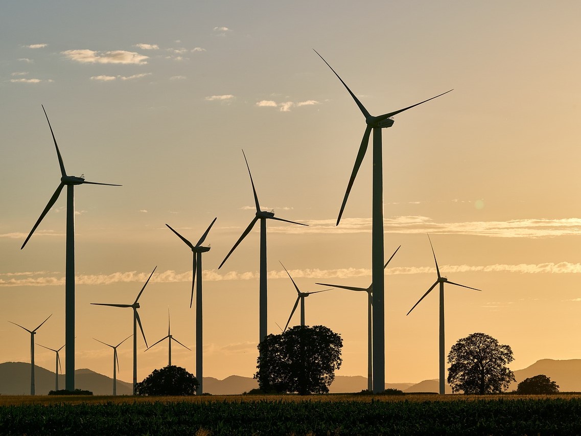 Wind turbines at sunset on a renewable energy wind farm